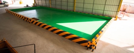 Covered indoor decontamination bay with bunded floor